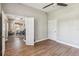 Spacious flex room with wood floors open to the dining area and featuring a neutral paint at 14205 Conifer Dr, Orlando, FL 32832