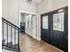 Inviting foyer features a staircase and double doors with decorative glass at 14205 Conifer Dr, Orlando, FL 32832