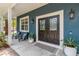 Inviting porch features double doors, stylish lanterns, and manicured landscaping at 14205 Conifer Dr, Orlando, FL 32832