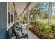Relaxing porch features blue Adirondack chairs, stylish lanterns, and manicured landscaping at 14205 Conifer Dr, Orlando, FL 32832