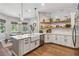 A modern kitchen featuring white cabinets, stainless steel appliances, and an open layout at 14205 Conifer Dr, Orlando, FL 32832