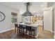 Bright kitchen featuring an island with seating, stainless steel range hood, and open shelving at 14205 Conifer Dr, Orlando, FL 32832
