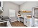 Bright laundry room with wood floors, white cabinets, sink, counter space, and natural light at 14205 Conifer Dr, Orlando, FL 32832