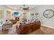 Comfortable living room featuring a fireplace, a large TV, neutral paint, and a ceiling fan at 14205 Conifer Dr, Orlando, FL 32832