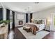 Elegant main bedroom featuring fireplace, wood floors, chandelier and large windows at 14205 Conifer Dr, Orlando, FL 32832