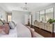 Spacious main bedroom boasts modern lighting, wood floors and large dresser with mirror at 14205 Conifer Dr, Orlando, FL 32832