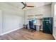 Bright office space with wood floors, ceiling fan, open shelving, and a large Remington gun safe at 14205 Conifer Dr, Orlando, FL 32832