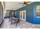 Outdoor patio with a table, benches, and fans, perfect for entertaining at 14205 Conifer Dr, Orlando, FL 32832