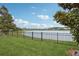 Fenced backyard featuring lawn and lake view at 1450 Chelsea Manor Cir, Deland, FL 32724