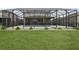 Fenced backyard with screened pool and landscaping at 1450 Chelsea Manor Cir, Deland, FL 32724