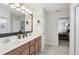 Bathroom featuring a double sink vanity, large mirror, and a view of the bedroom at 1450 Chelsea Manor Cir, Deland, FL 32724