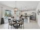 Dining area leading to a modern kitchen and sliding doors to the pool at 1450 Chelsea Manor Cir, Deland, FL 32724