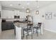 Bright kitchen with gray and white cabinets, granite countertops, stainless steel appliances, and island with pendant lighting at 1450 Chelsea Manor Cir, Deland, FL 32724