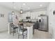 Modern kitchen with stainless steel appliances, white cabinets, and granite counters at 1450 Chelsea Manor Cir, Deland, FL 32724