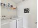 Laundry room with washer, dryer, and overhead storage shelves at 1450 Chelsea Manor Cir, Deland, FL 32724
