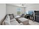 Comfortable living room with a large sectional, TV, and neutral tones at 1450 Chelsea Manor Cir, Deland, FL 32724
