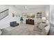 Bright living room with neutral walls, tile floors, comfortable seating and art at 1450 Chelsea Manor Cir, Deland, FL 32724