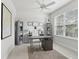 Bright office with a large window, ceiling fan, desk, and bookshelves at 1450 Chelsea Manor Cir, Deland, FL 32724