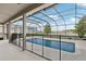 Screened pool with lake view, safety fence, and outdoor living space at 1450 Chelsea Manor Cir, Deland, FL 32724