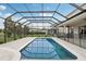 Screened pool with manicured lawn, patio, and outdoor seating at 1450 Chelsea Manor Cir, Deland, FL 32724