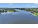 Expansive aerial view of a peaceful lake surrounded by lush green trees and countryside at 16386 Se 156Th Place Rd, Weirsdale, FL 32195
