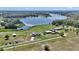 Aerial view of estate with well-maintained grounds, home, outbuildings, and lake access at 16386 Se 156Th Place Rd, Weirsdale, FL 32195