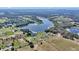 Scenic aerial view highlighting the lakefront property's peaceful setting with verdant landscape at 16386 Se 156Th Place Rd, Weirsdale, FL 32195
