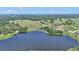 Stunning aerial shot showcasing the lake surrounded by vast landscapes, trees, and fields at 16386 Se 156Th Place Rd, Weirsdale, FL 32195