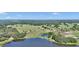 Breathtaking aerial shot of a lake surrounded by rolling hills, trees, and farmland at 16386 Se 156Th Place Rd, Weirsdale, FL 32195