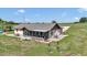 Spacious backyard featuring a comfortable patio, screened in porch, and lush green grass at 16386 Se 156Th Place Rd, Weirsdale, FL 32195