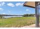 Expansive backyard featuring a picturesque view of the serene lake and lush green space at 16386 Se 156Th Place Rd, Weirsdale, FL 32195