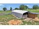 Metal barn structure on a grassy, fenced field at 16386 Se 156Th Place Rd, Weirsdale, FL 32195