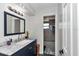Modern bathroom featuring granite counters, new fixture and a shower at 16386 Se 156Th Place Rd, Weirsdale, FL 32195