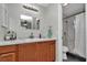 Modern bathroom with wood cabinets, marble countertop, and stylish fixtures at 16386 Se 156Th Place Rd, Weirsdale, FL 32195