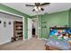 Bedroom featuring a closet, ceiling fan and convenient hall access at 16386 Se 156Th Place Rd, Weirsdale, FL 32195