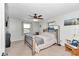Cozy bedroom with carpet, a ceiling fan, and serene windows, ideal for relaxation and restful nights at 16386 Se 156Th Place Rd, Weirsdale, FL 32195