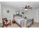 Comfortable bedroom with natural light, a ceiling fan, and a charming, relaxed atmosphere; inviting and serene at 16386 Se 156Th Place Rd, Weirsdale, FL 32195