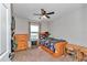 Cozy bedroom with wood furniture, ceiling fan, and window at 16386 Se 156Th Place Rd, Weirsdale, FL 32195