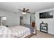 Inviting bedroom features a ceiling fan, TV, and neutral tones, creating a relaxing and welcoming space at 16386 Se 156Th Place Rd, Weirsdale, FL 32195