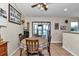 Charming dining area with a round table and chairs, complemented by natural light and views of the outdoors at 16386 Se 156Th Place Rd, Weirsdale, FL 32195
