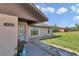 Inviting home exterior features a well-manicured lawn, a cozy bench, and a clear house number at 16386 Se 156Th Place Rd, Weirsdale, FL 32195