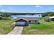 Inviting single-Gathering home on a sprawling lot with scenic lake views and a well-maintained lawn at 16386 Se 156Th Place Rd, Weirsdale, FL 32195