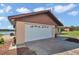 Attached one-car garage with a white door and decorative windows providing ample parking at 16386 Se 156Th Place Rd, Weirsdale, FL 32195