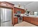 Modern kitchen boasts stainless steel appliances, wooden cabinets, and granite countertops for a sleek design at 16386 Se 156Th Place Rd, Weirsdale, FL 32195