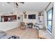 Spacious living room with tile floors, deer mounts, and a large TV; an ideal space for relaxing and entertaining at 16386 Se 156Th Place Rd, Weirsdale, FL 32195