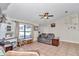 Comfortable living room featuring tile floors, a ceiling fan, and a neutral color scheme at 16386 Se 156Th Place Rd, Weirsdale, FL 32195