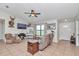 Comfortable living room featuring tile floors, a ceiling fan and a neutral color scheme at 16386 Se 156Th Place Rd, Weirsdale, FL 32195