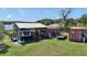 Versatile property featuring an RV under a shed, storage containers, and ample outdoor space at 16386 Se 156Th Place Rd, Weirsdale, FL 32195