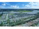 Expansive aerial perspective capturing a neighborhood near a tranquil lake, displaying neatly arranged homes and green spaces at 16768 Sanctuary Dr, Winter Garden, FL 34787