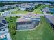 Aerial view of a lovely house with a screened-in pool set against a backdrop of a well-manicured lawn at 16768 Sanctuary Dr, Winter Garden, FL 34787